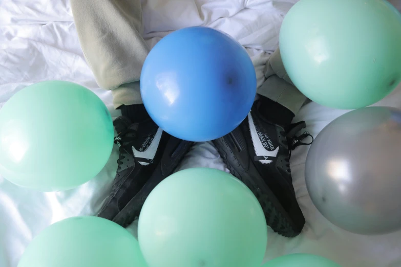 blue and grey balloons, one green and one black and one white