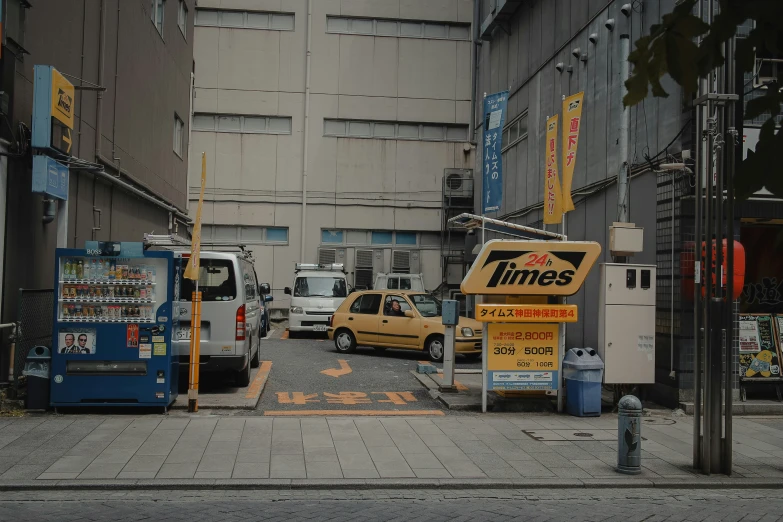 vehicles and street signs on the side of a city street