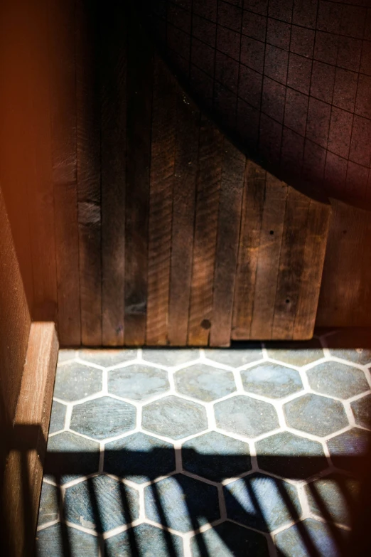 wooden gate next to tiled floor in public setting