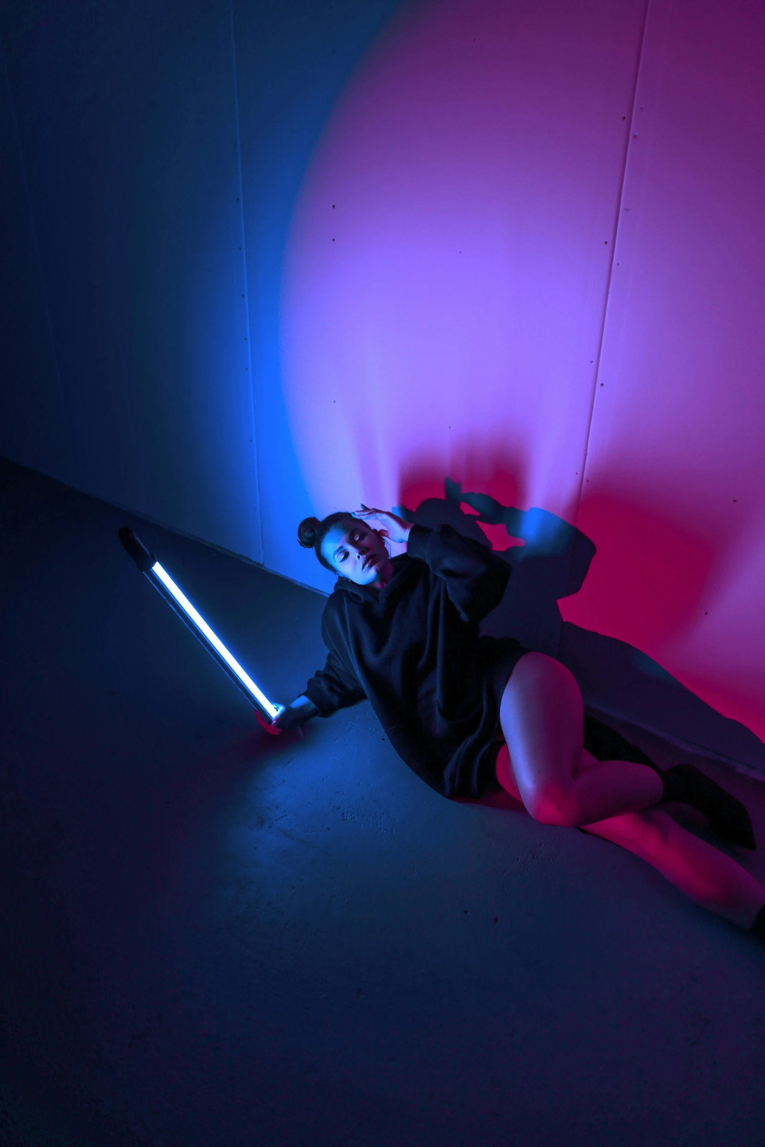 a star wars sith leion laying down with a light saber