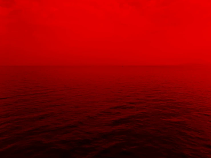 red sky over the ocean on an empty red background