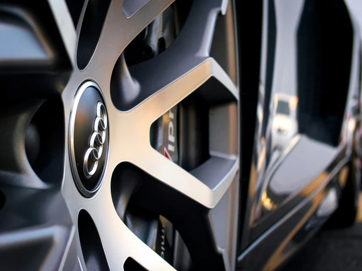 the rims on a black car in a parking lot