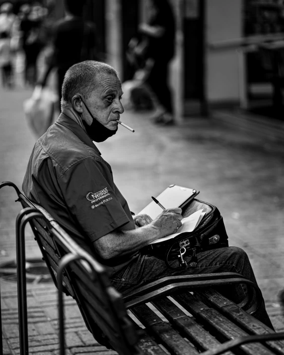 an elderly man sitting on a bench smoking a cigarette