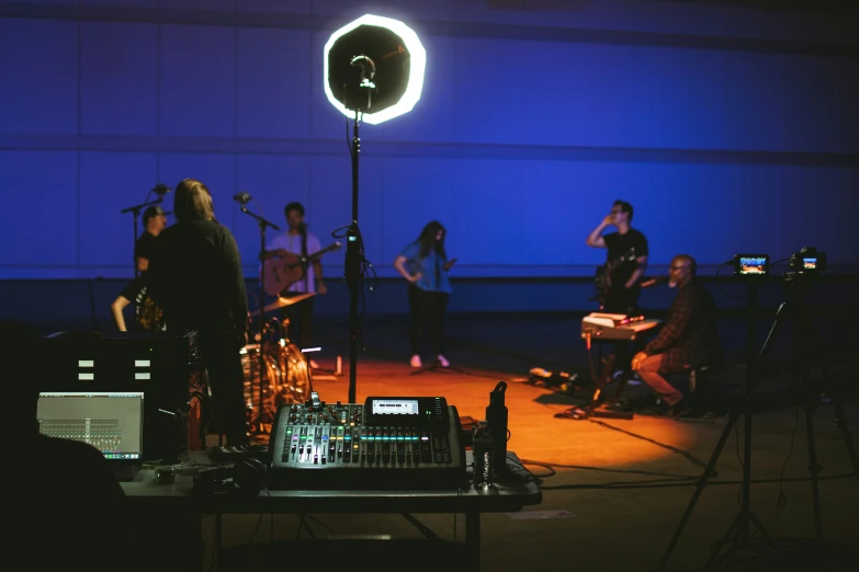 a recording studio with a dj, recorder and a po - video camera