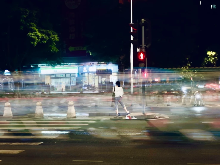 a person on a street at night riding a skateboard