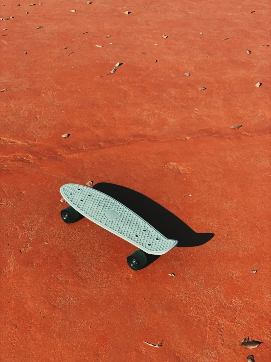 a black and white surf board laying on the ground