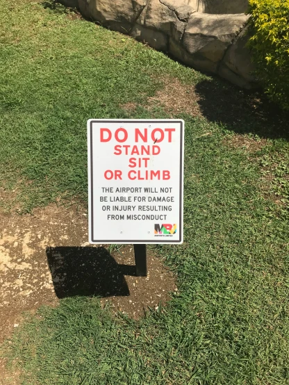 an amusing do not stand sign at a cemetery