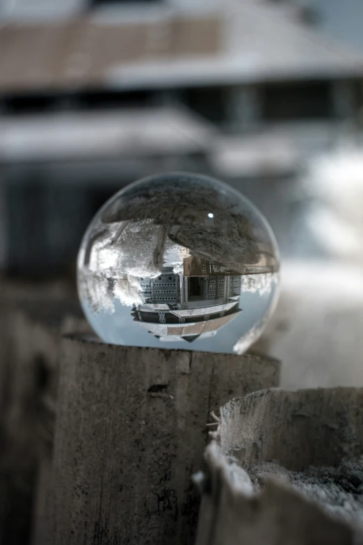 a picture of an old building that is reflected in a ball