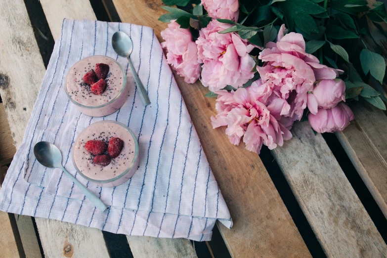 two desserts with strawberries sit on a napkin