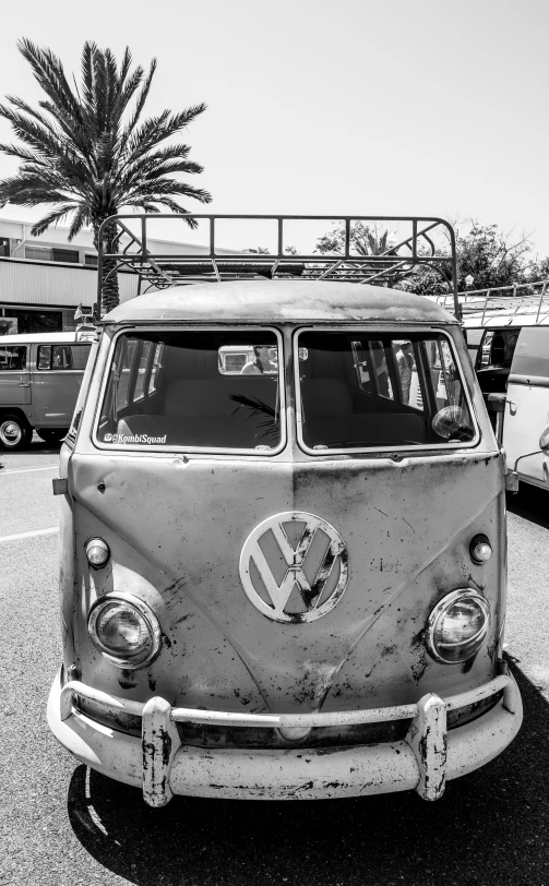 the front of a van with a surf board on it