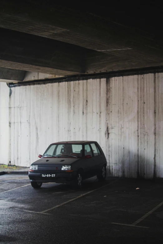 a small car sitting parked in a parking lot