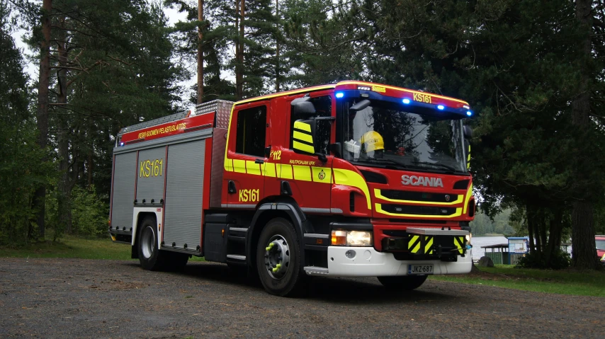 a red fire engine is parked in the lot