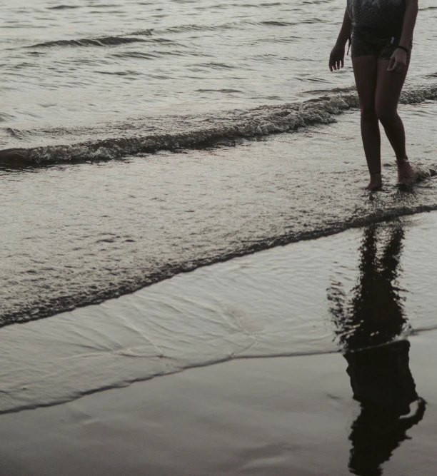 a  standing at the shore of a lake