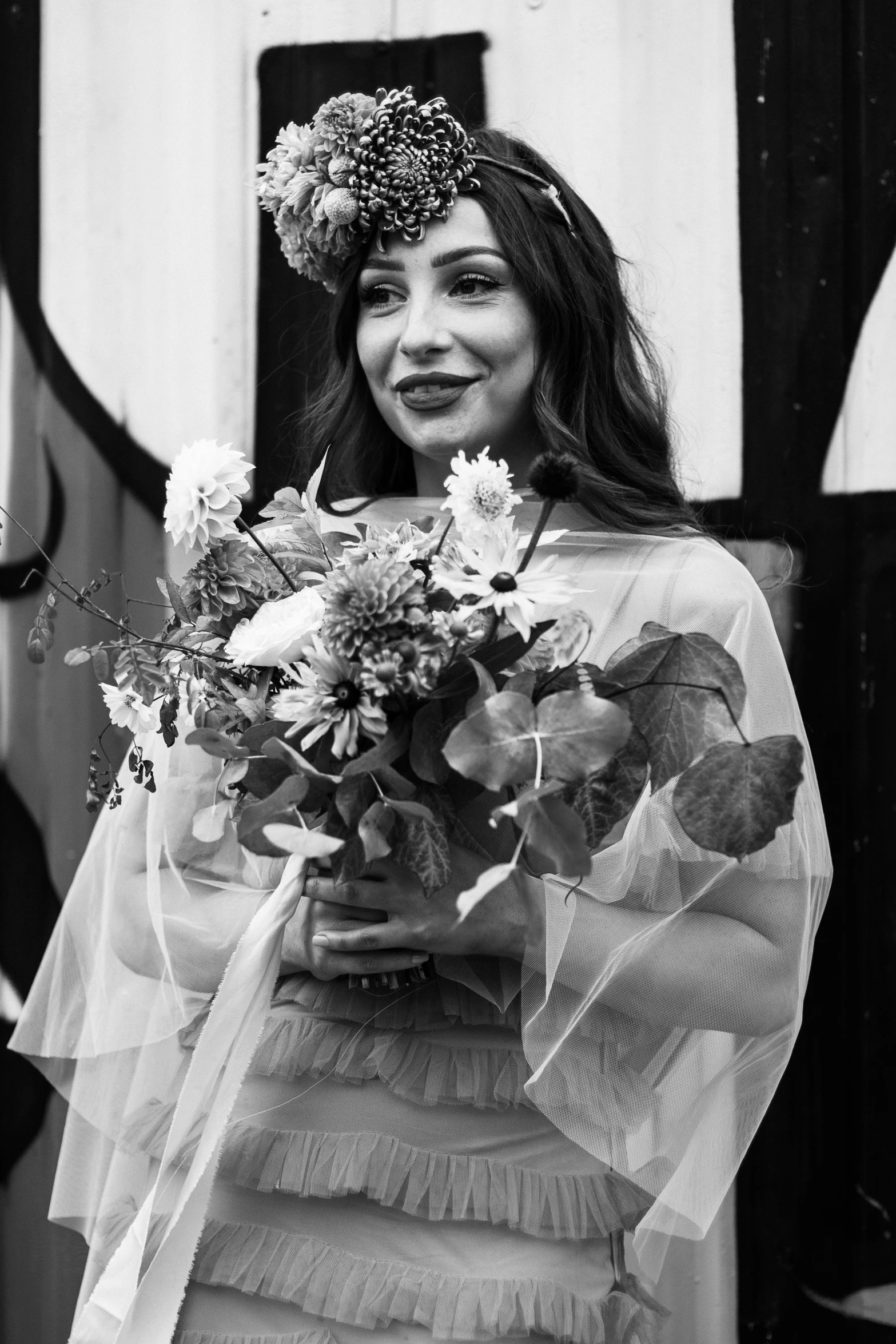 a woman with long dark hair in a veil and flowers