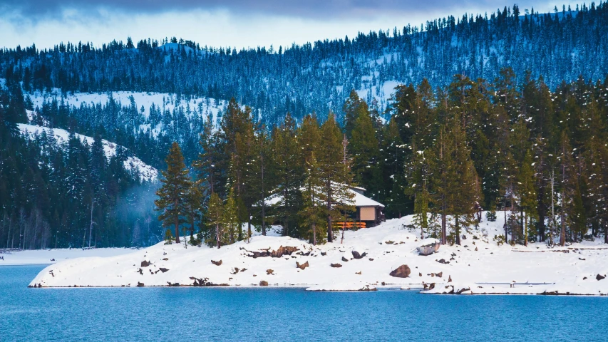 a cabin sitting on top of a snow covered island