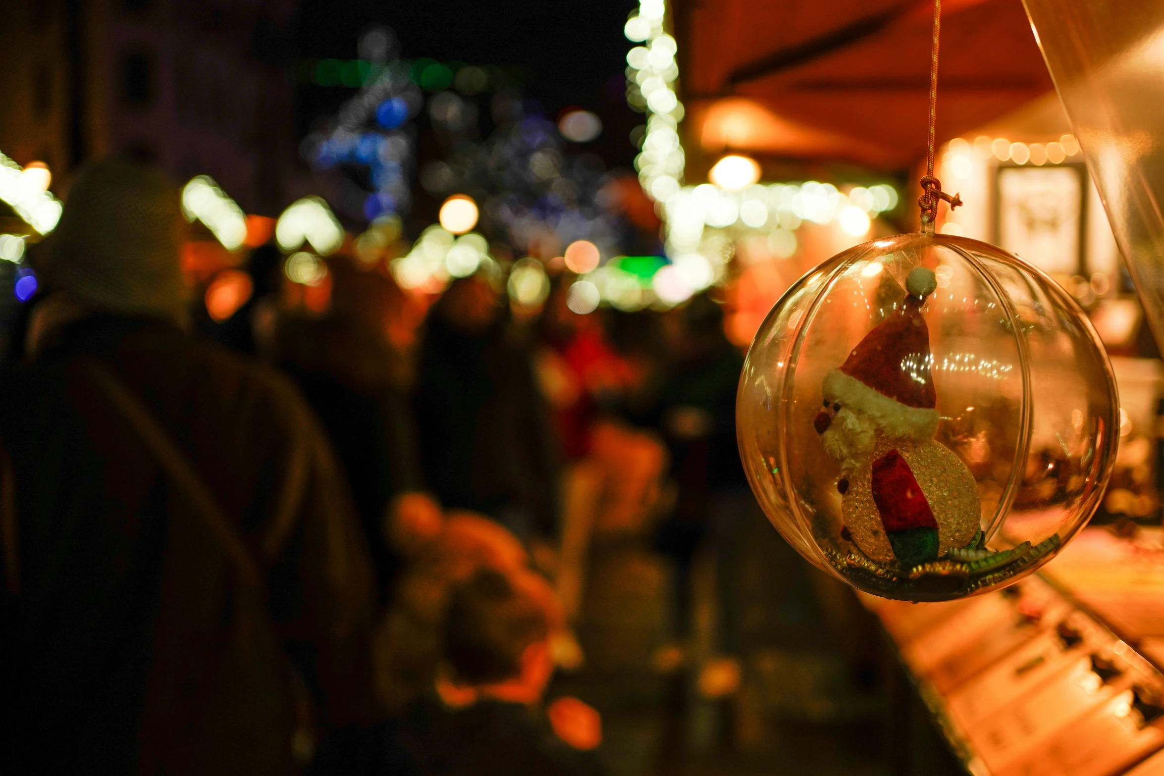 a glass ornament hanging in a crowd of people