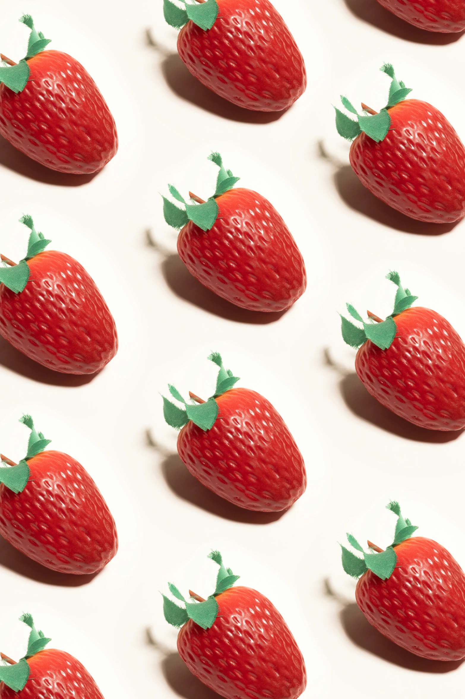 red strawberries with green leaves and a white background