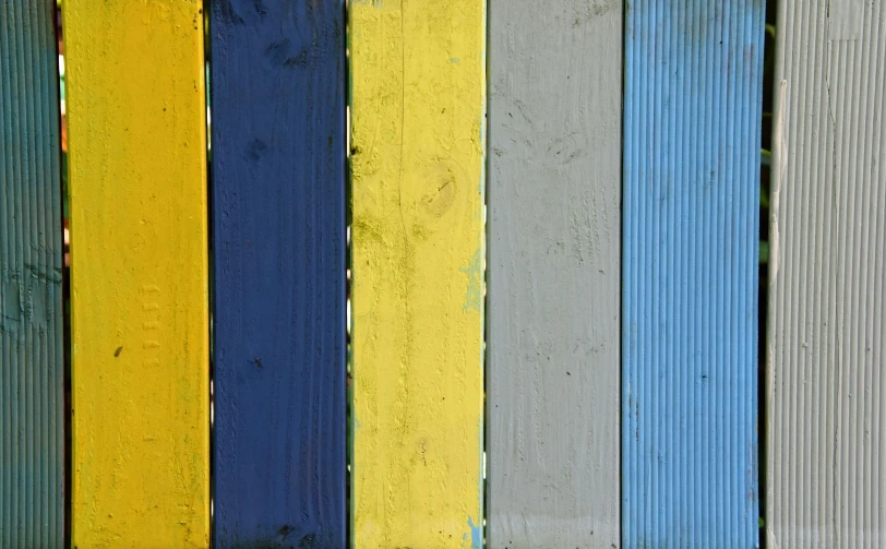 colorful strips of paint painted on wood paneling