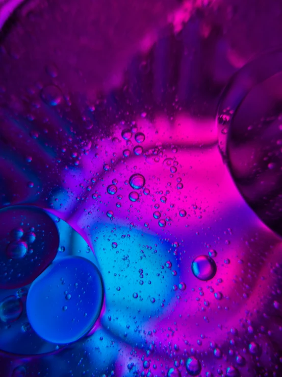 a blue and pink liquid substance on top of a purple sink
