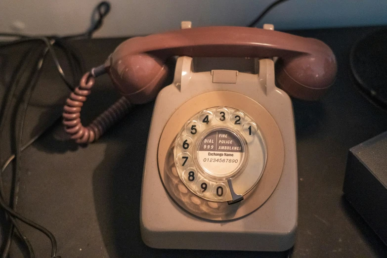 an old phone with its cord out on the ground