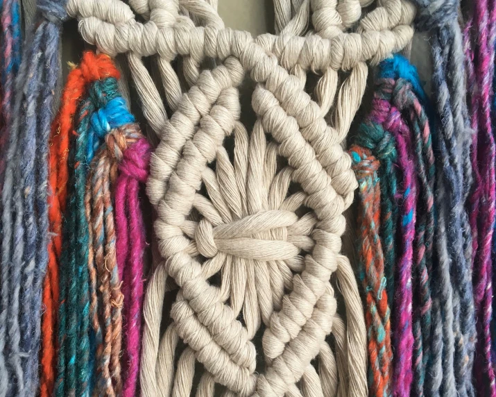 an assortment of multicolored ropes tied up on top of a table