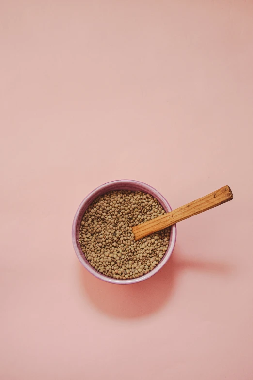 a bowl filled with brown food next to an egg and cinnamon