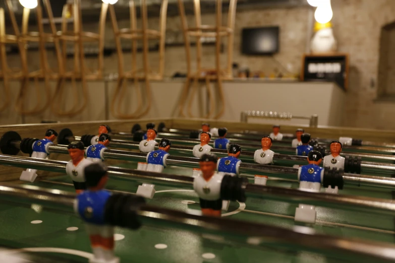 a foo - o - ball table has a large group of men standing on it