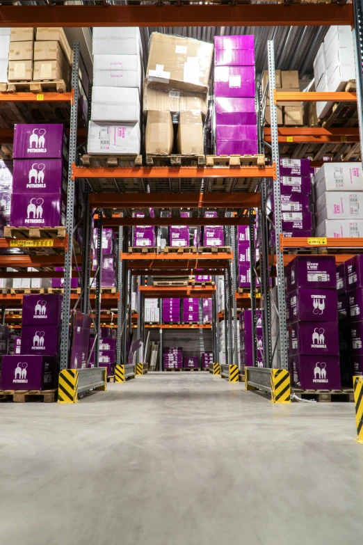 purple boxes on a long rail are piled high