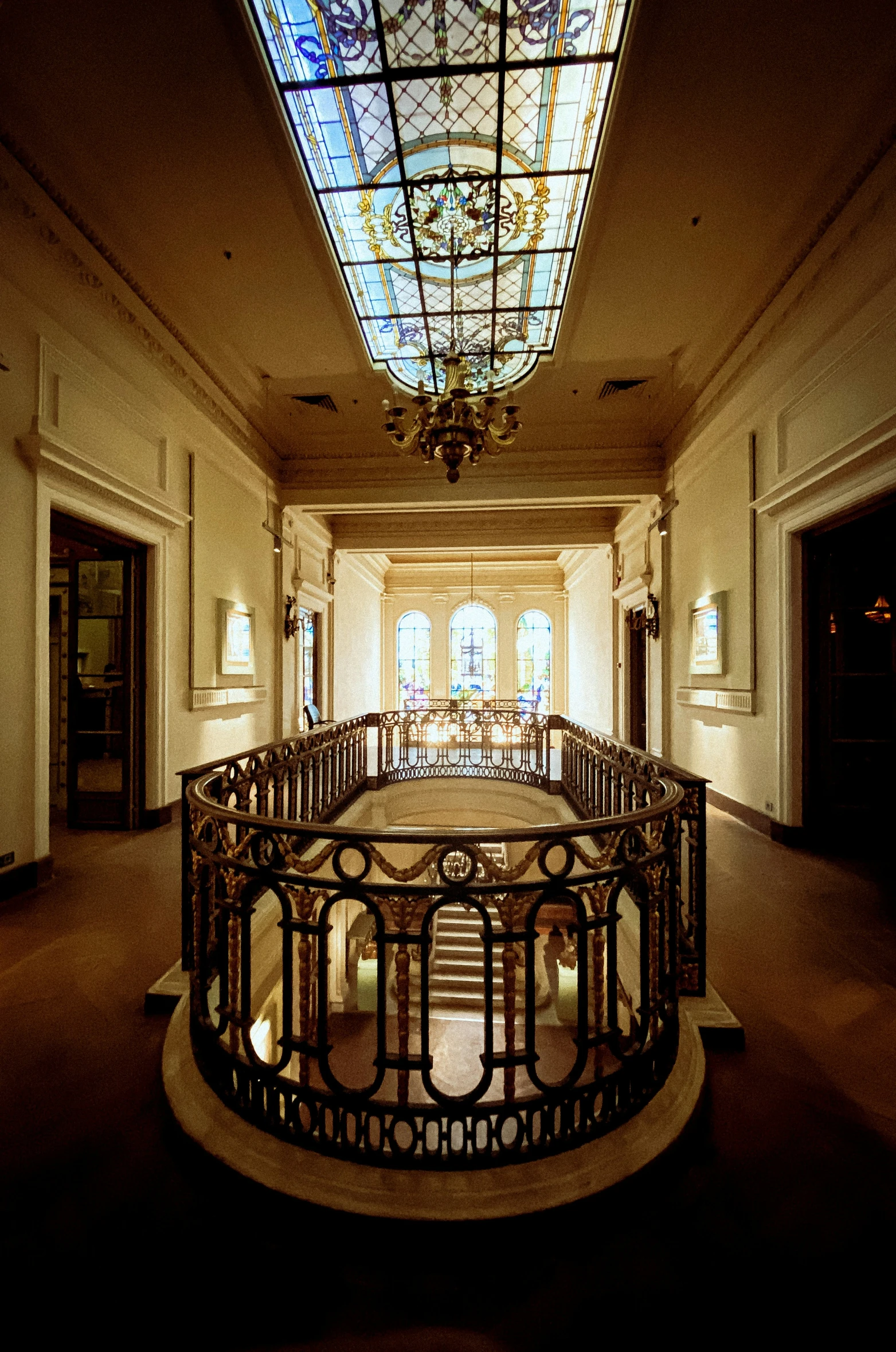 a fancy hallway in a museum with chandelier