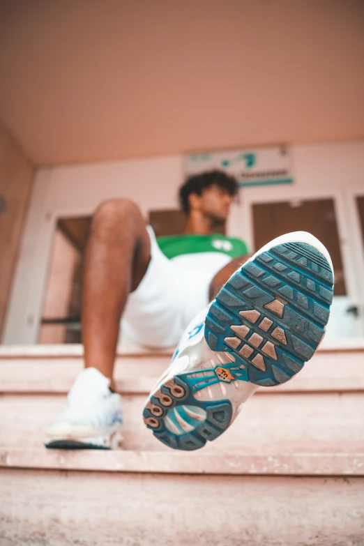 a tennis player resting on the porch of his house