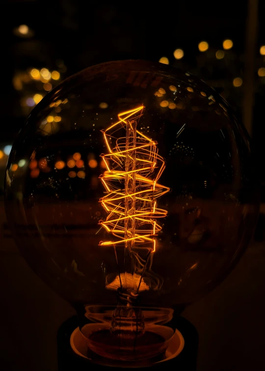 a glowing light bulb with a tree in it