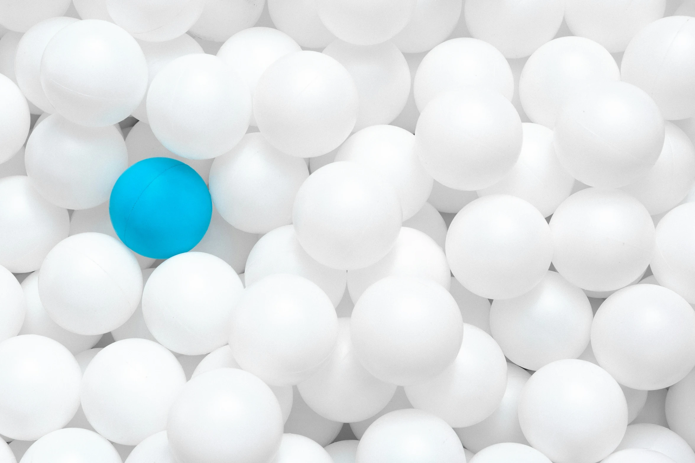 a blue object in white balls with the ground below