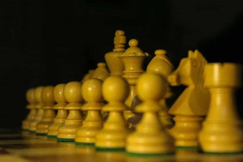several wooden chess pieces on a brown table
