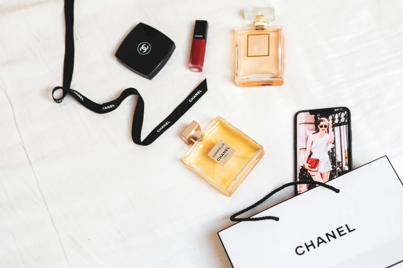 an image of a bag with various perfumes on top of it