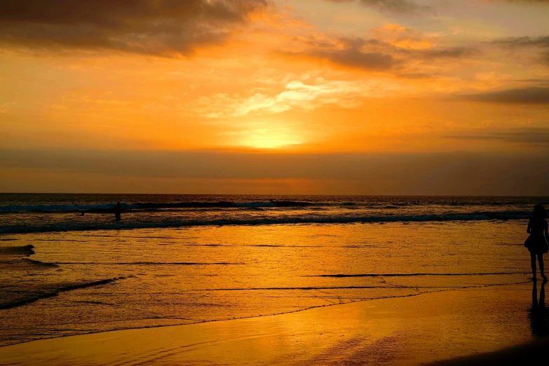 the sun is rising over the ocean and waves