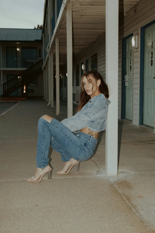 a woman sitting on the side of a building