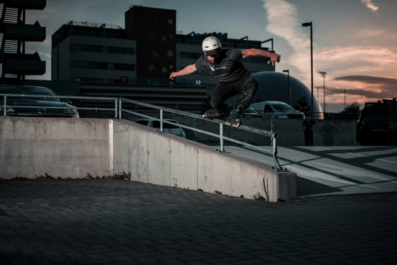 a young man riding a skateboard down a rail