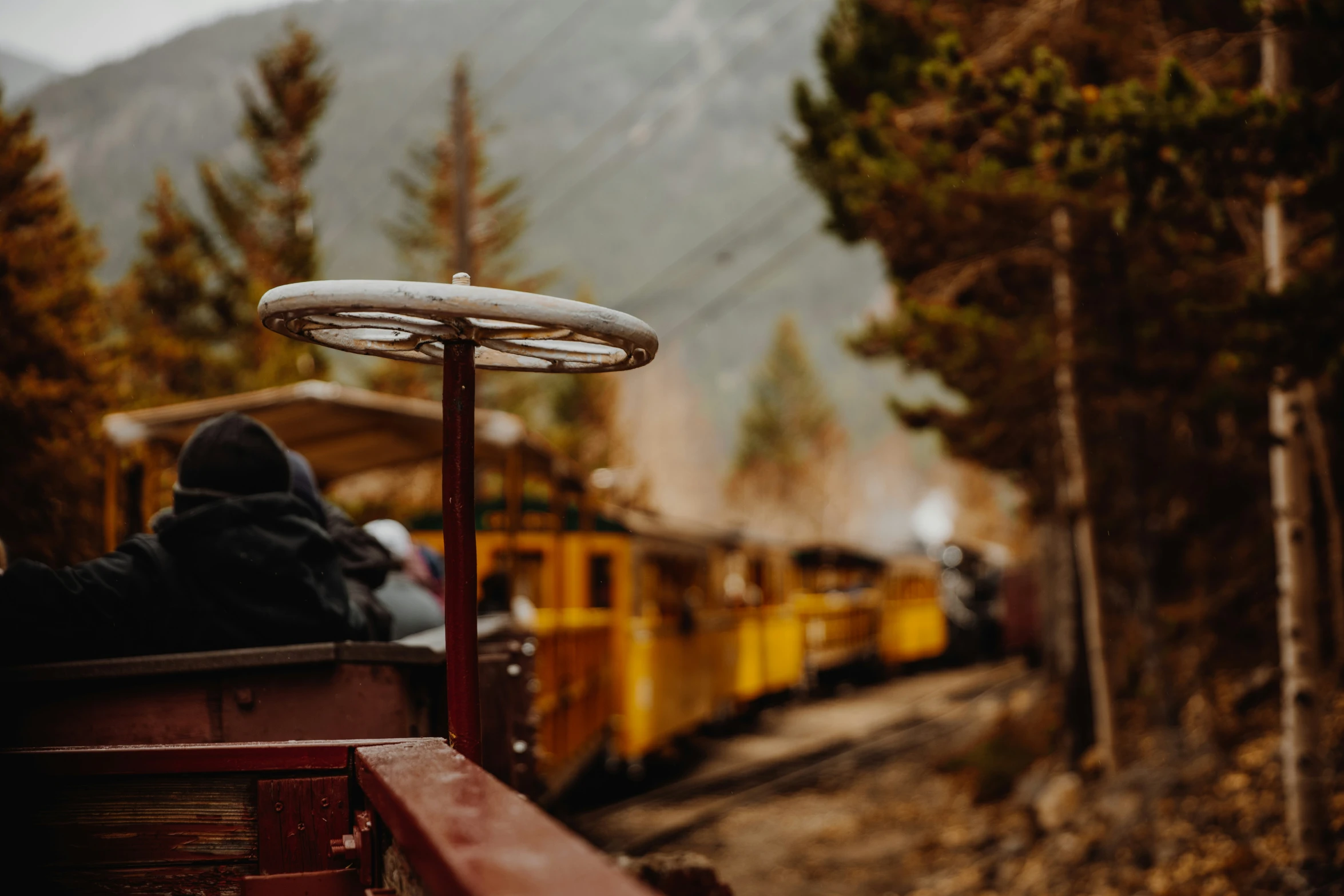 an old fashioned yellow train has its passenger inside