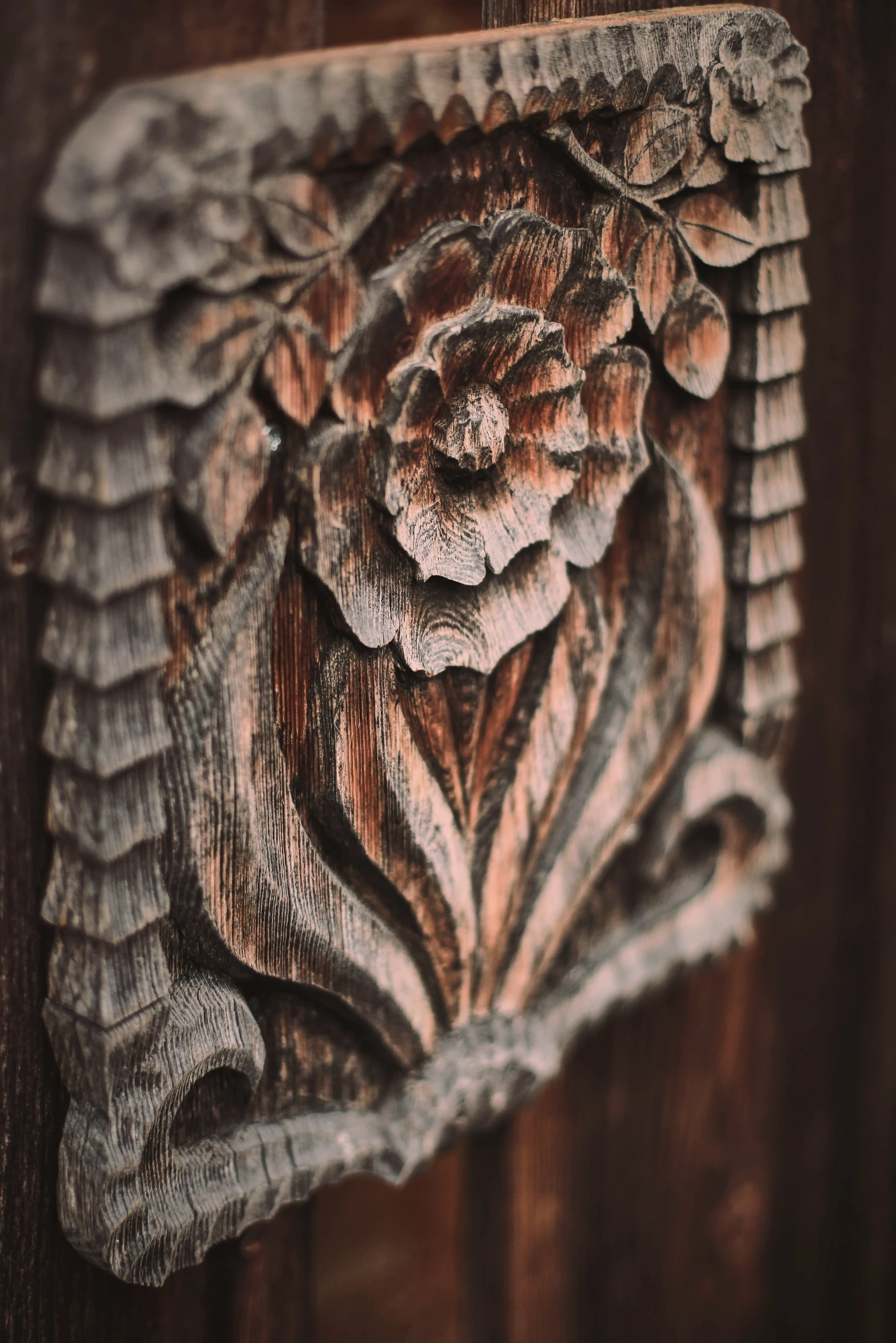 a flower is carved on a wall and wooden panel