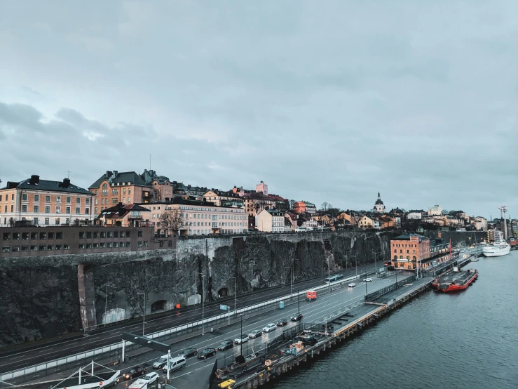 a city next to the ocean under a cloudy sky