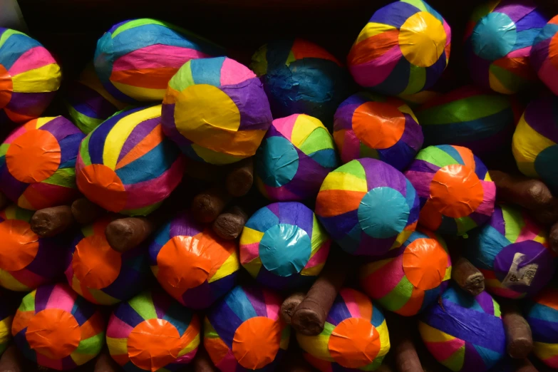 a pile of brightly colored balls and poles