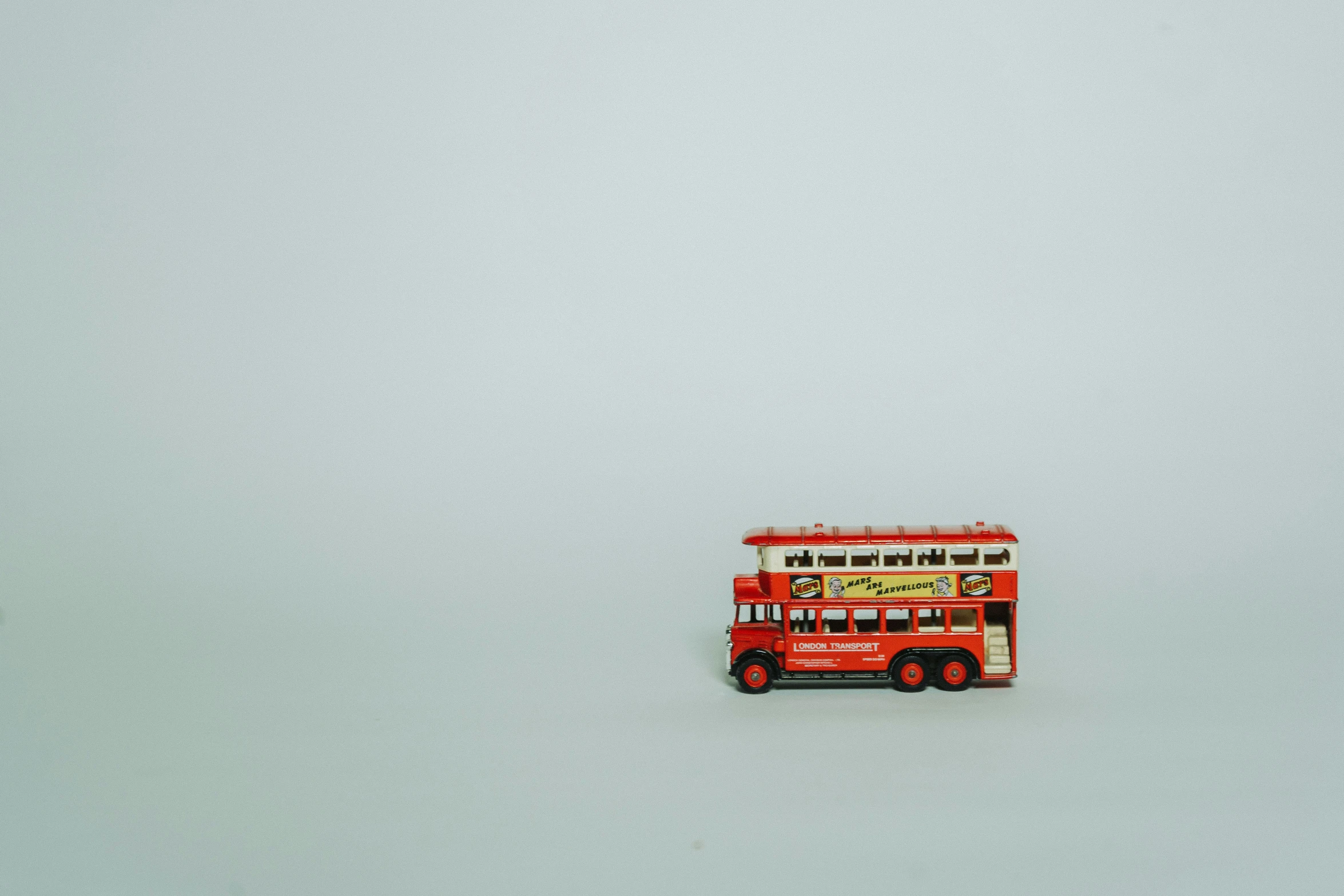 a double decked bus traveling across a white snow covered field