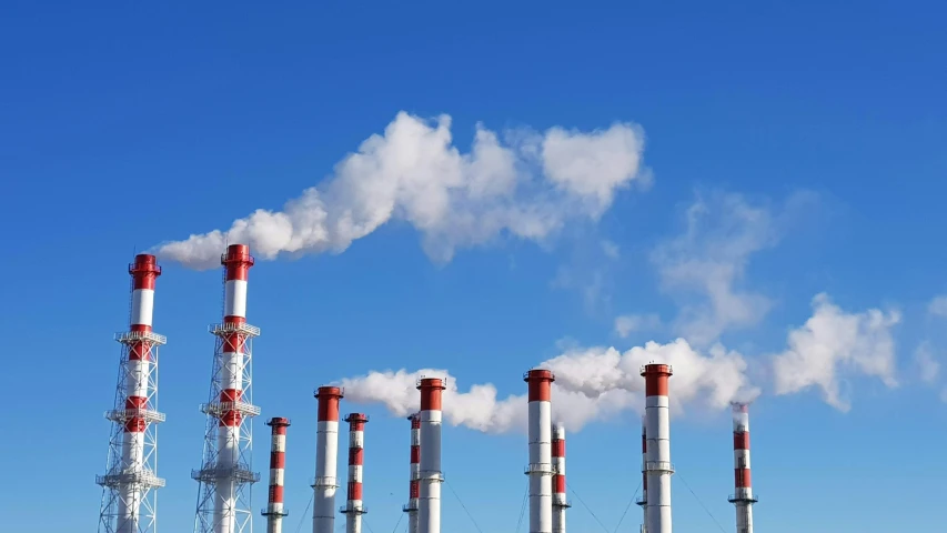 smoke comes out of a tall pipe stack