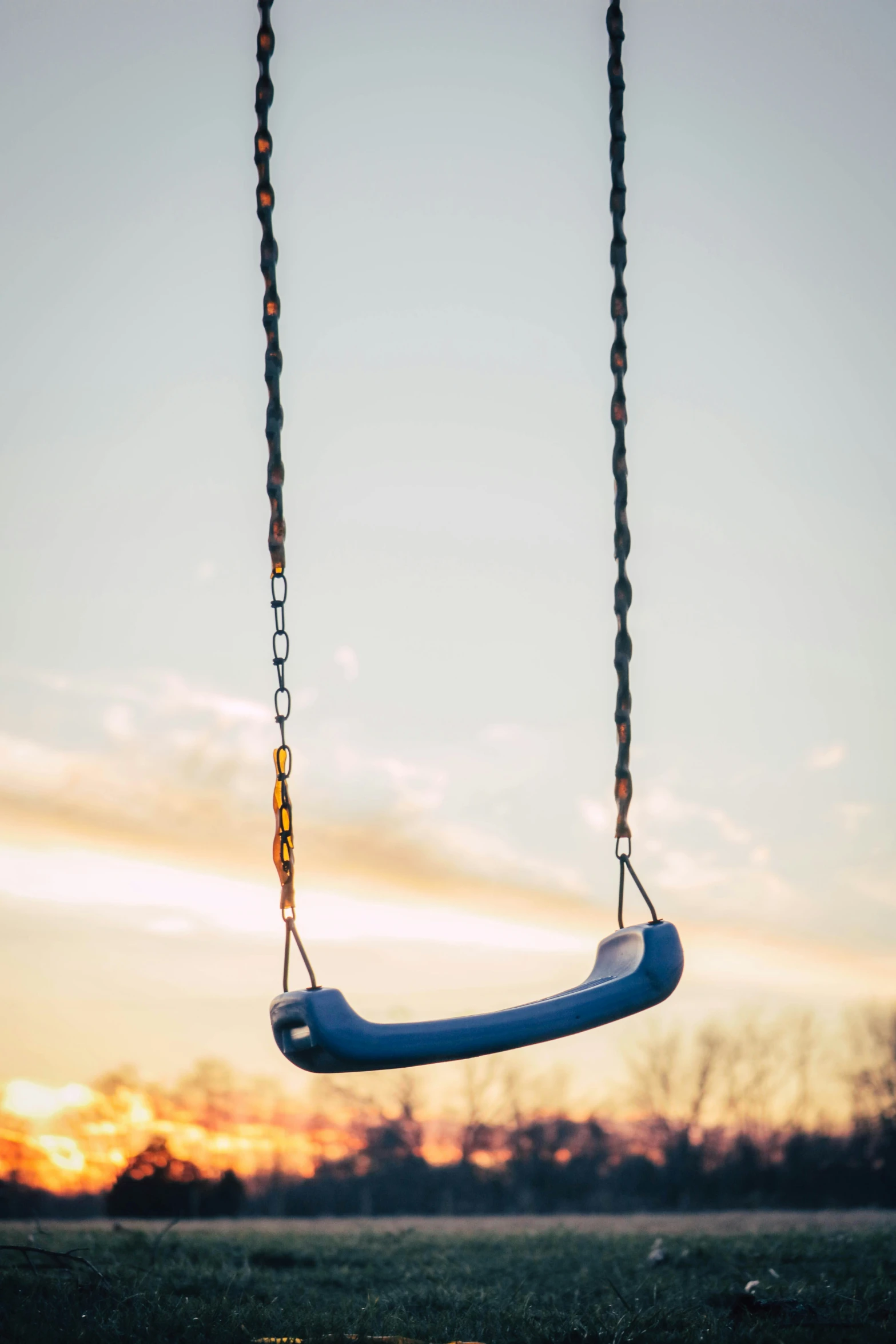 a child's swing that is hung up in the sky