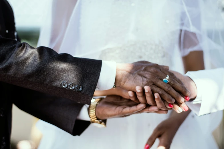 the couple is holding hands as they stand in front of each other