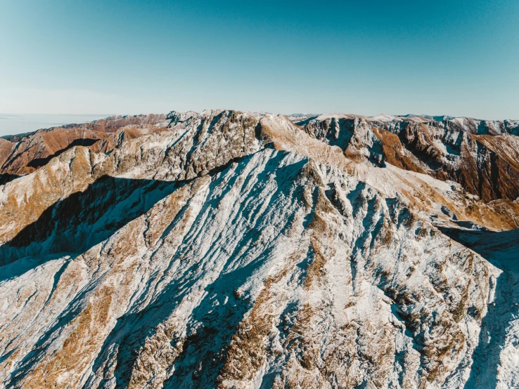 snow capped mountain tops with blue sky in the background