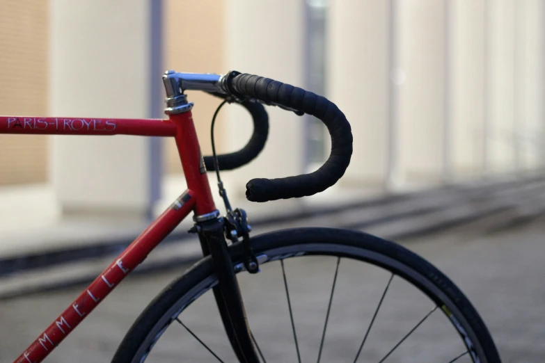 a red bicycle is parked in the street