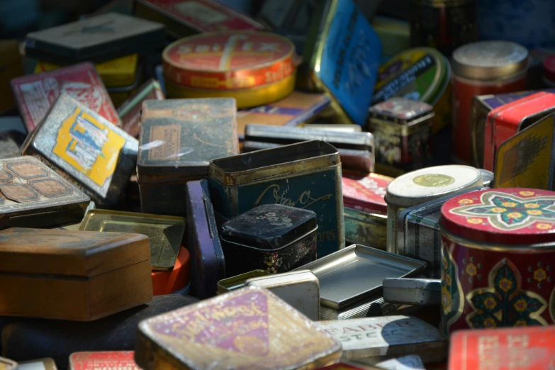 a pile of assorted small tins and containers