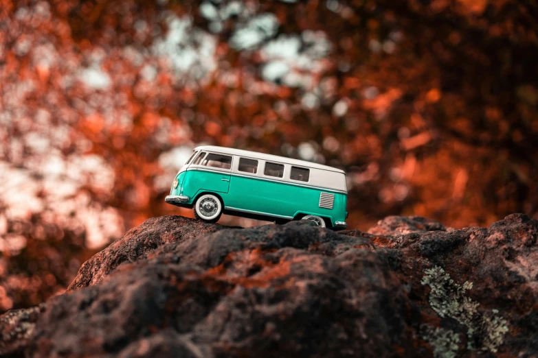 the model van is sitting on top of a rock