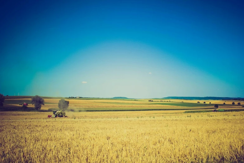 there is a tractor being driven by two people